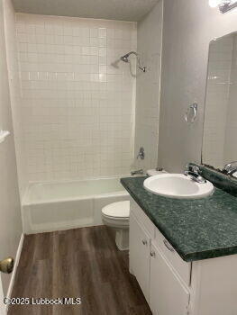 5309 22nd Street Lubbock, TX 79407 - Photo 7 of 13 a bathroom with a granite countertop sink a toilet and shower