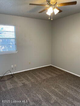 5309 22nd Street Lubbock, TX 79407 - Photo 9 of 13 an empty room with windows and fan