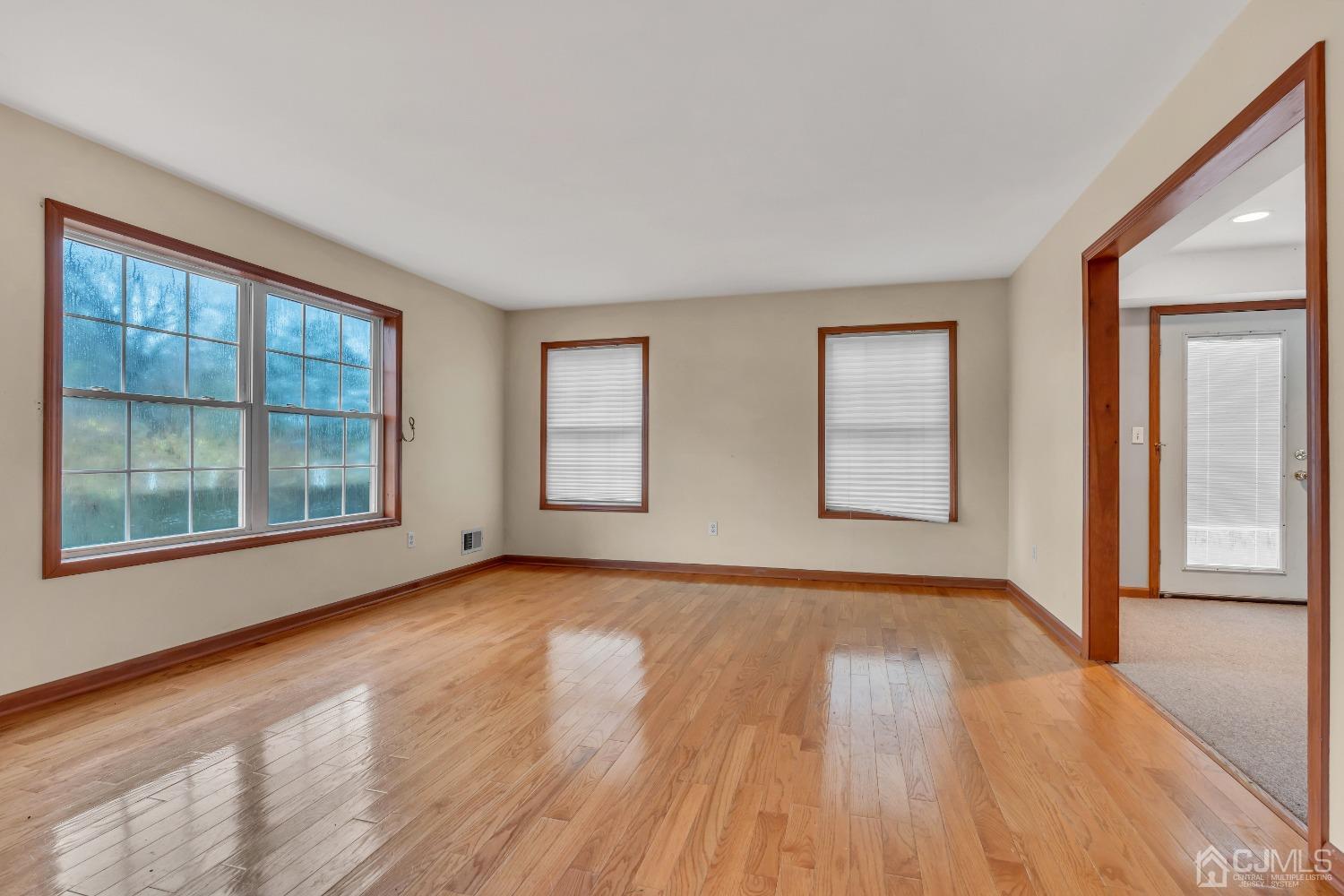 231 Station Road Monroe Township, NJ 08831 - Photo 12 of 36 a view of an empty room with wooden floor and a window