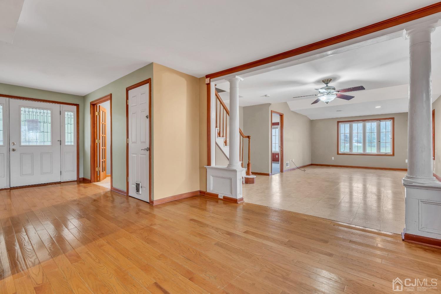 231 Station Road Monroe Township, NJ 08831 - Photo 17 of 36 a view of an empty room with wooden floor and a window