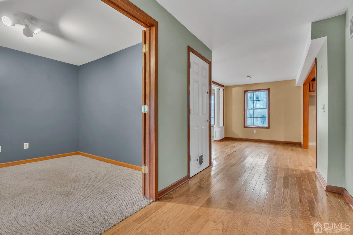231 Station Road Monroe Township, NJ 08831 - Photo 5 of 36 a view of an empty room with wooden floor and a window