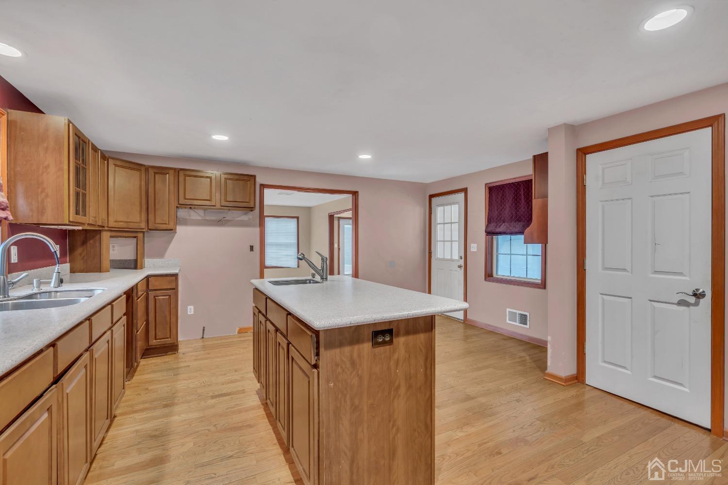 231 Station Road Monroe Township, NJ 08831 - Photo 8 of 36 a kitchen with a sink a refrigerator and wooden cabinets