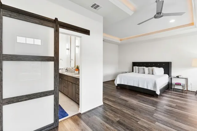 a bedroom with a bed and wooden floor