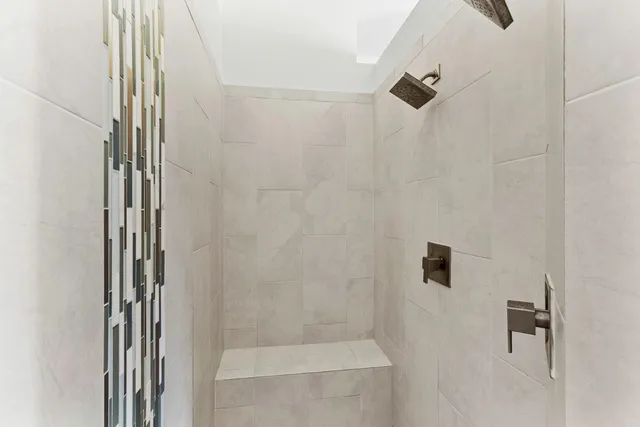 a bathroom with a granite countertop double vanity sink and a mirror