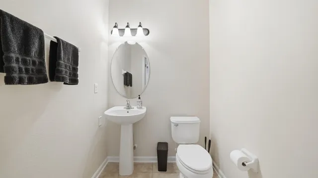 a bathroom with a granite countertop sink a mirror a bathtub and next to a window