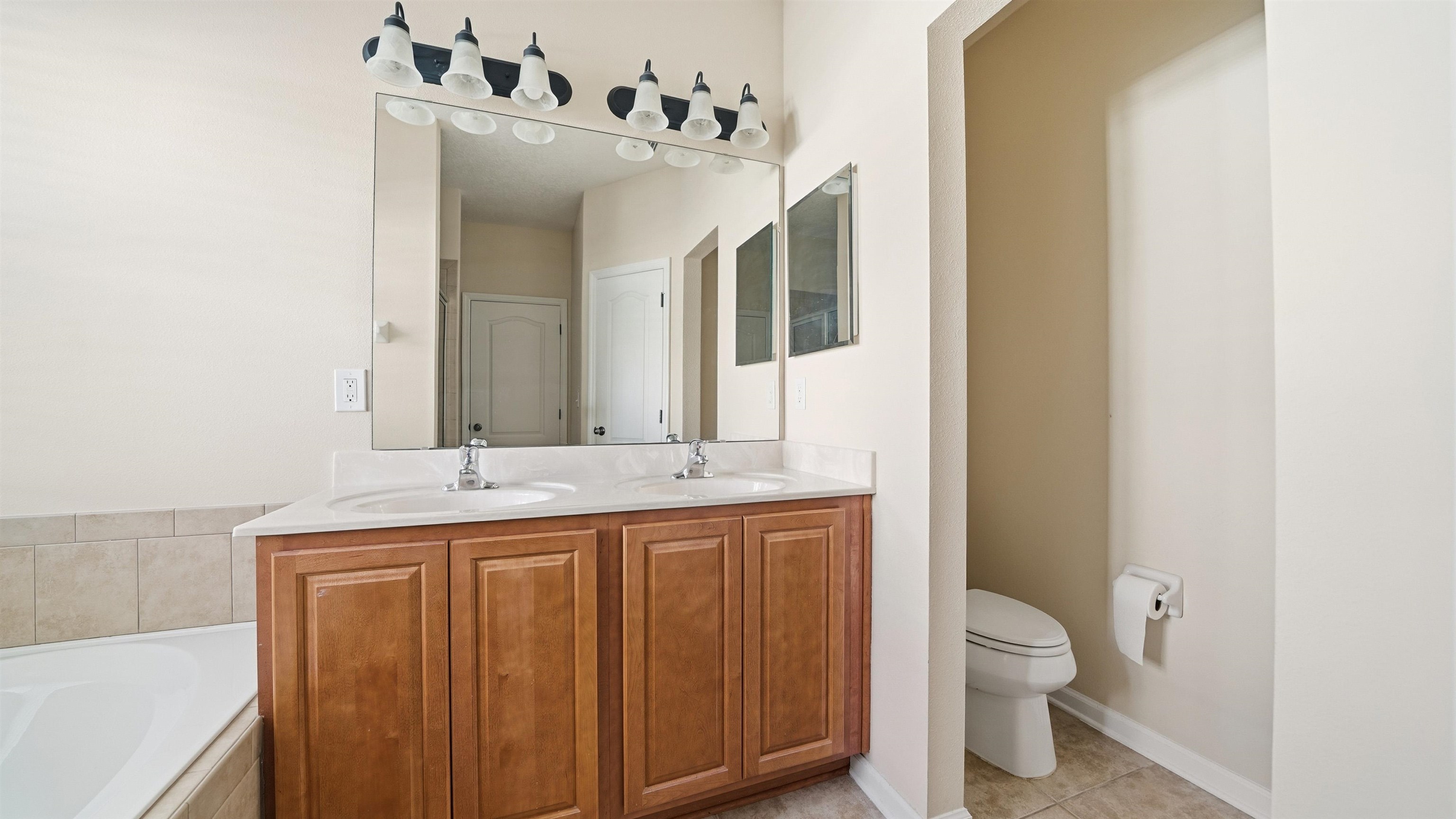 1121 Overdale Road St. Augustine, FL 32080 - Photo 17 of 65 a bathroom with a granite countertop sink mirror vanity and toilet