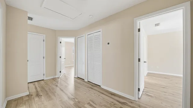an aerial view of residential houses with outdoor space and trees