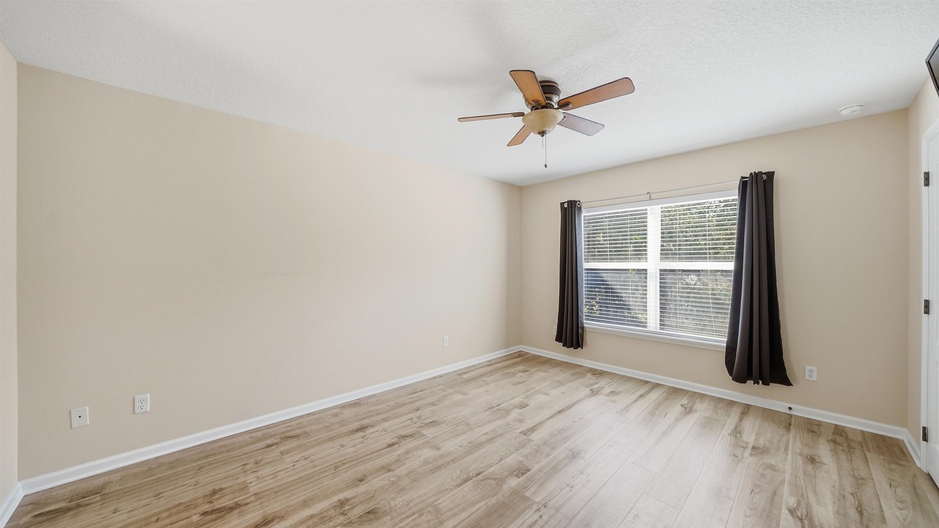 1121 Overdale Road St. Augustine, FL 32080 - Photo 25 of 65 a view of empty room with wooden floor and fan