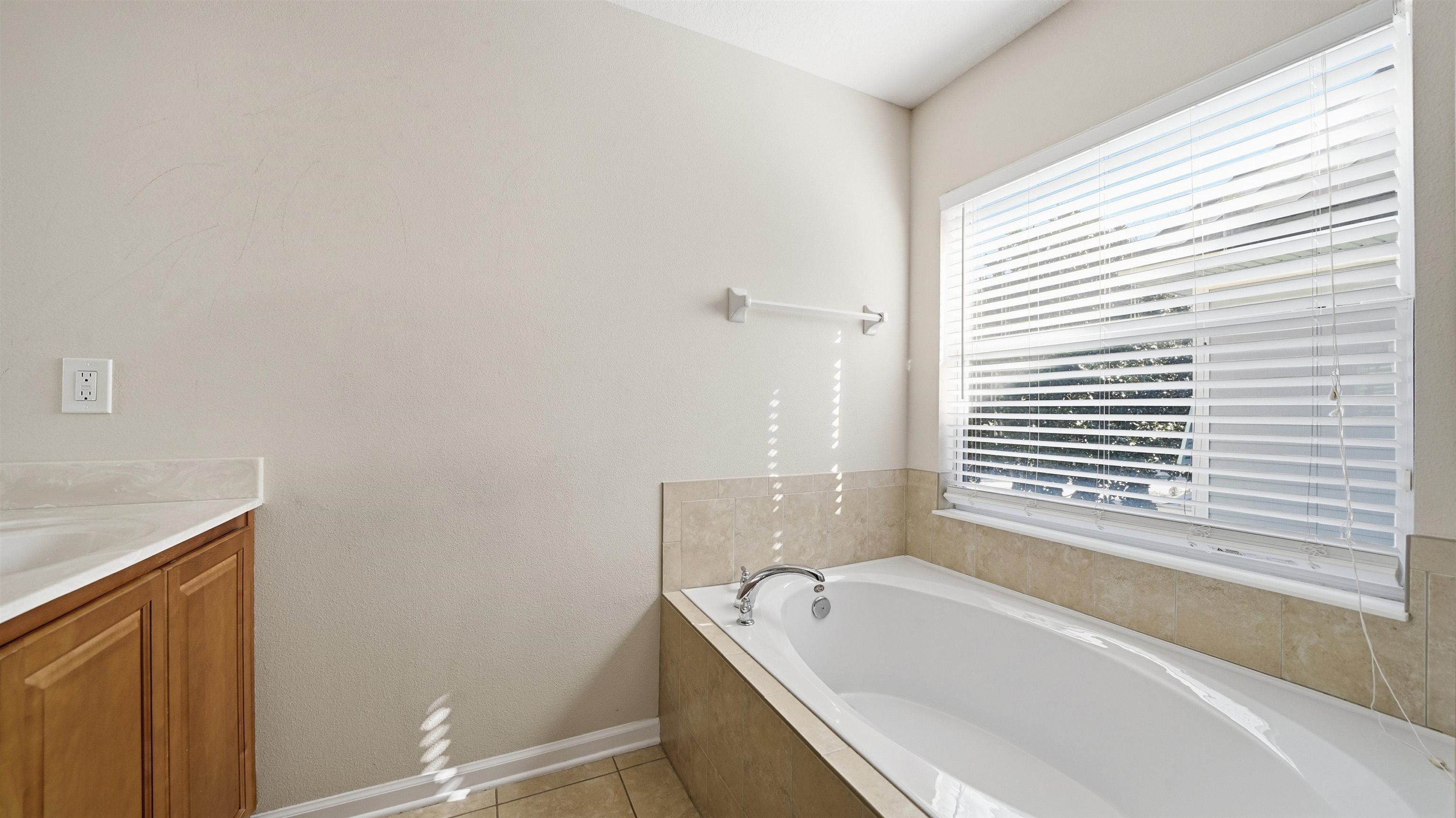 1121 Overdale Road St. Augustine, FL 32080 - Photo 29 of 65 Bathroom with vanity, a bath, and light tile patterned flooring