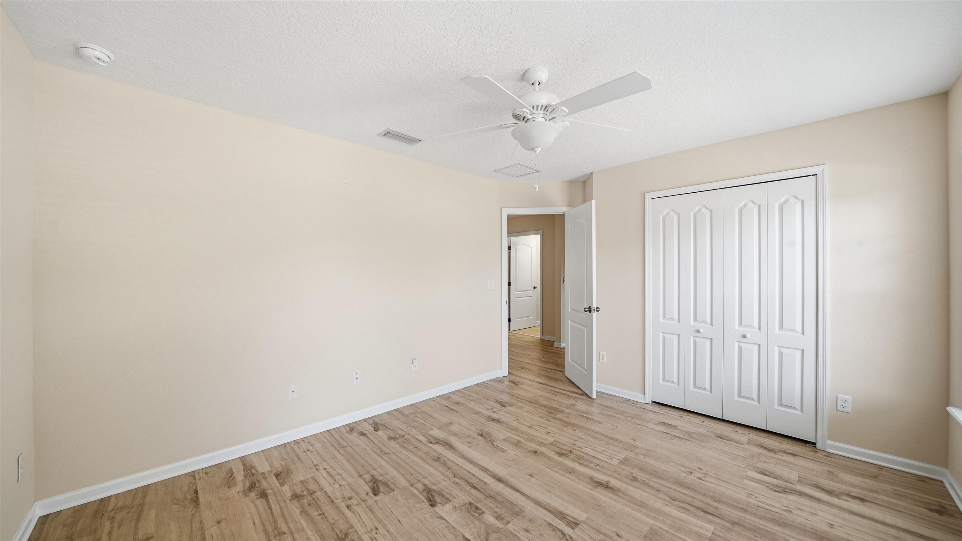 1121 Overdale Road St. Augustine, FL 32080 - Photo 32 of 65 an empty room with wooden floor fan and windows
