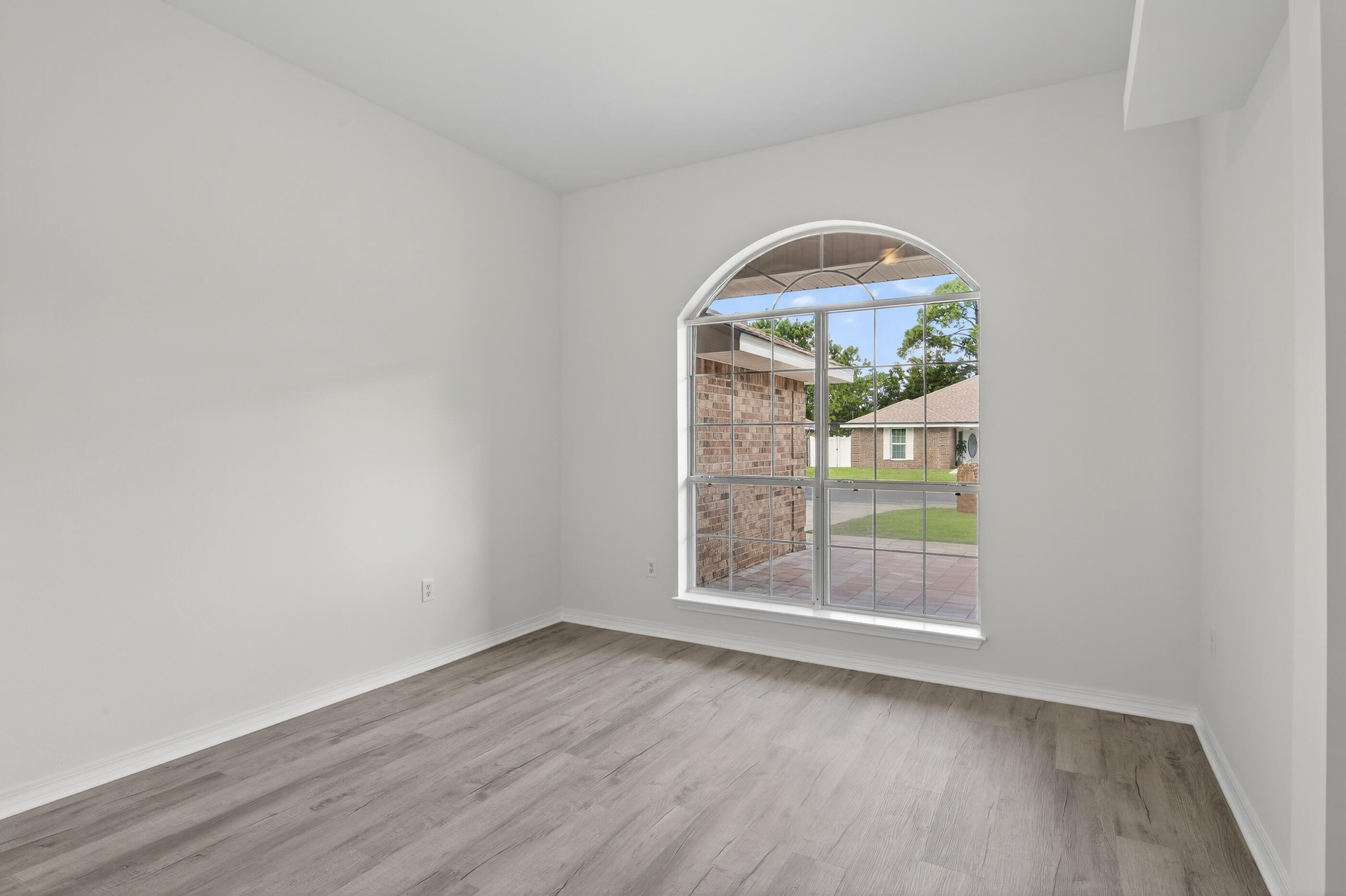 151 Beacon Way Miramar Beach, FL 32550 - Photo 24 of 42 an empty room with wooden floor and windows