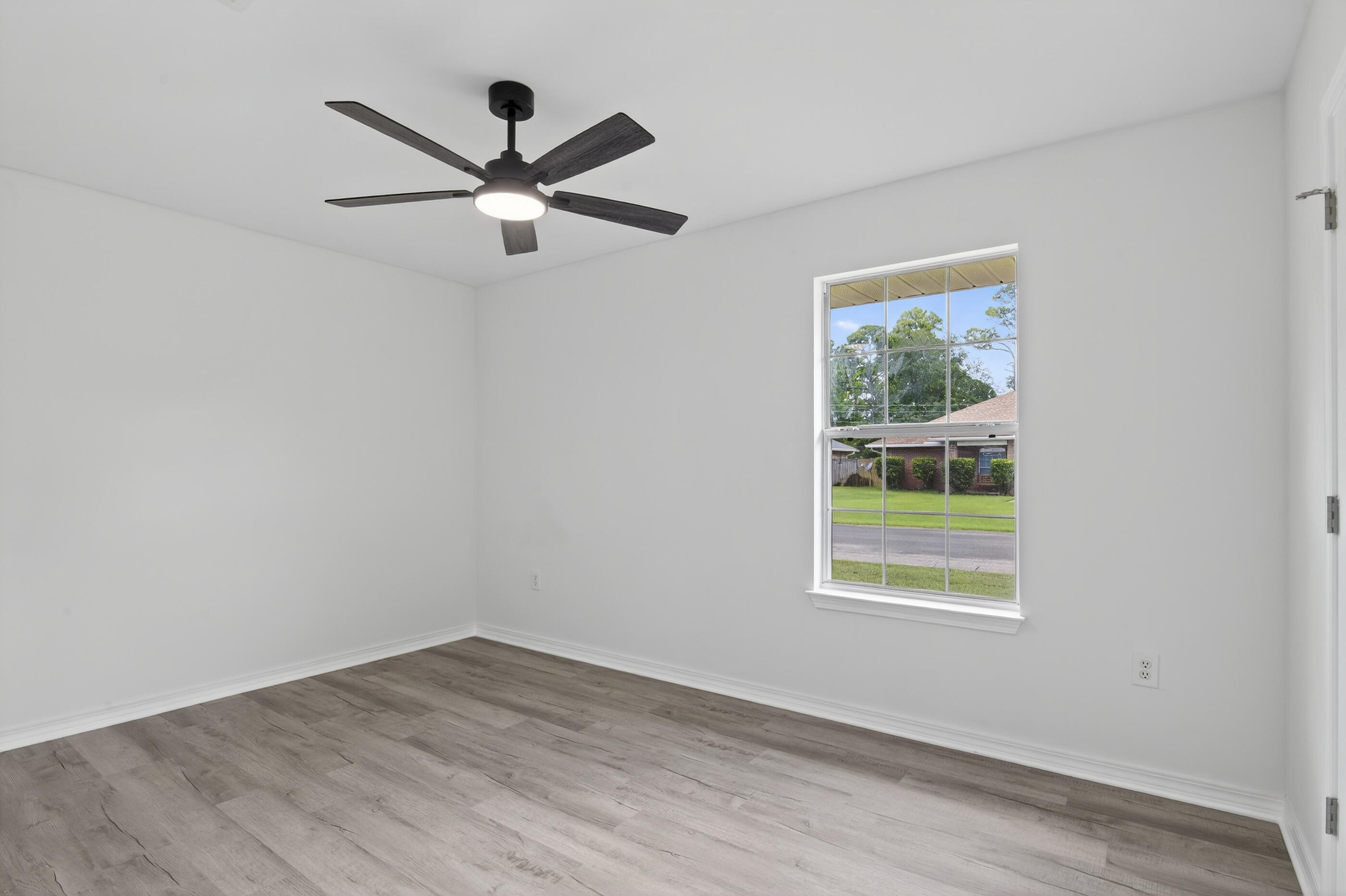 151 Beacon Way Miramar Beach, FL 32550 - Photo 30 of 42 an empty room with wooden floor and windows
