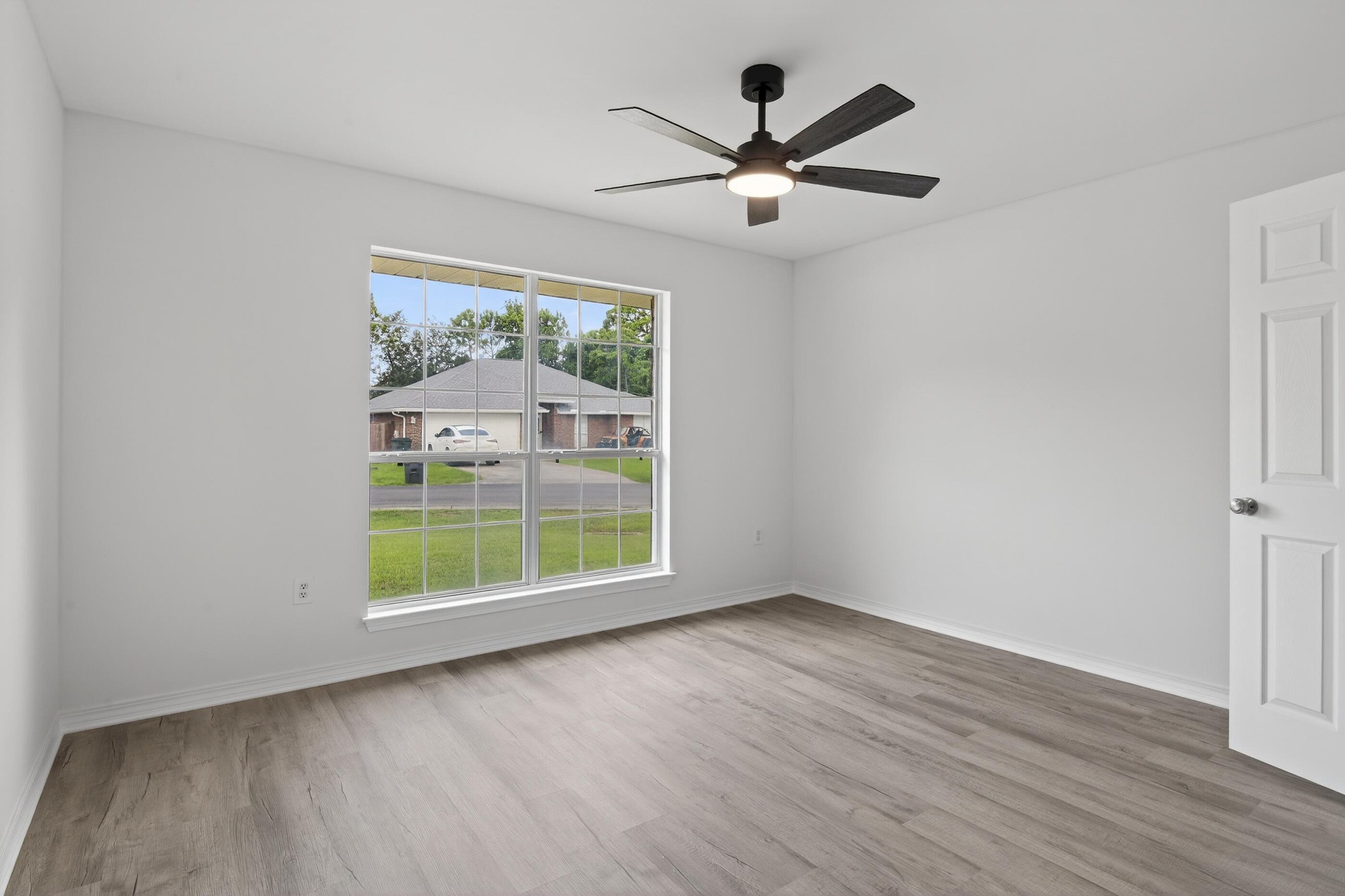 151 Beacon Way Miramar Beach, FL 32550 - Photo 31 of 42 an empty room with wooden floor fan and windows