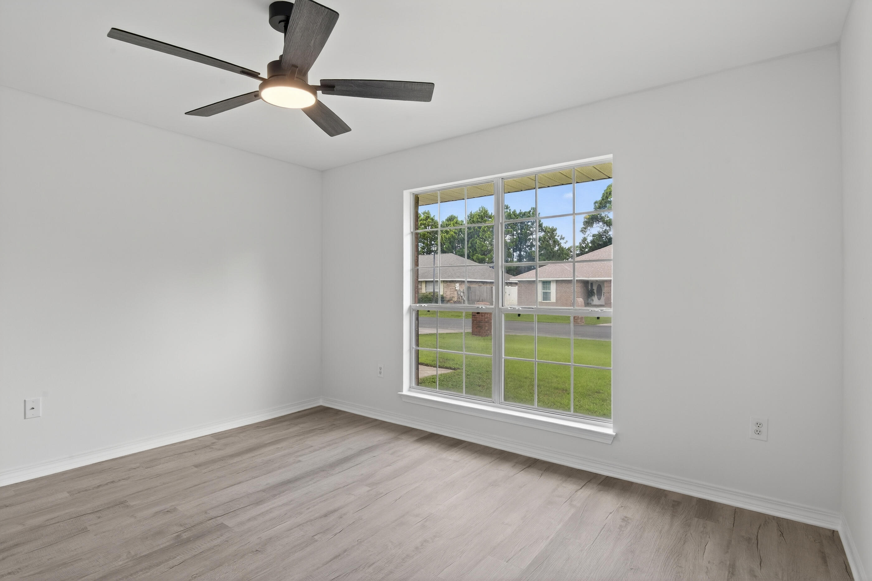 151 Beacon Way Miramar Beach, FL 32550 - Photo 32 of 42 an empty room with wooden floor fan and windows