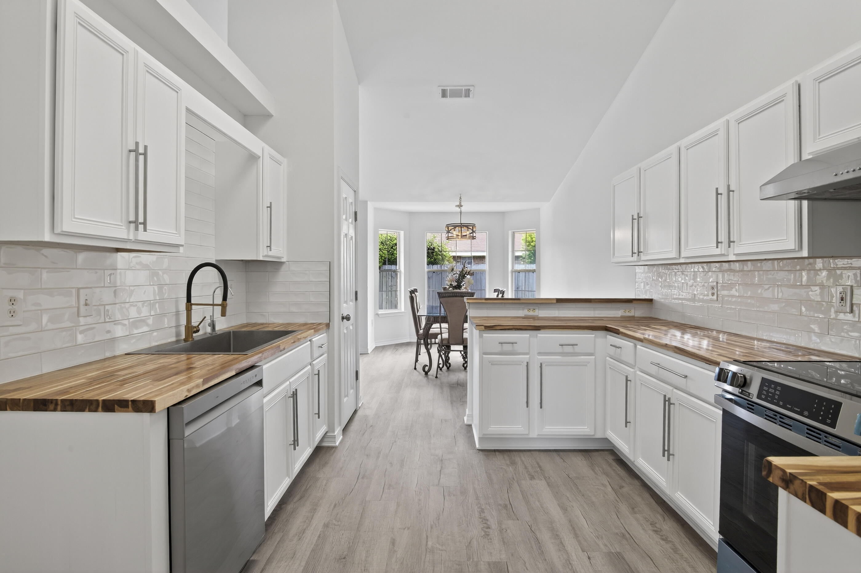 151 Beacon Way Miramar Beach, FL 32550 - Photo 6 of 42 a kitchen with a sink white cabinets and appliances