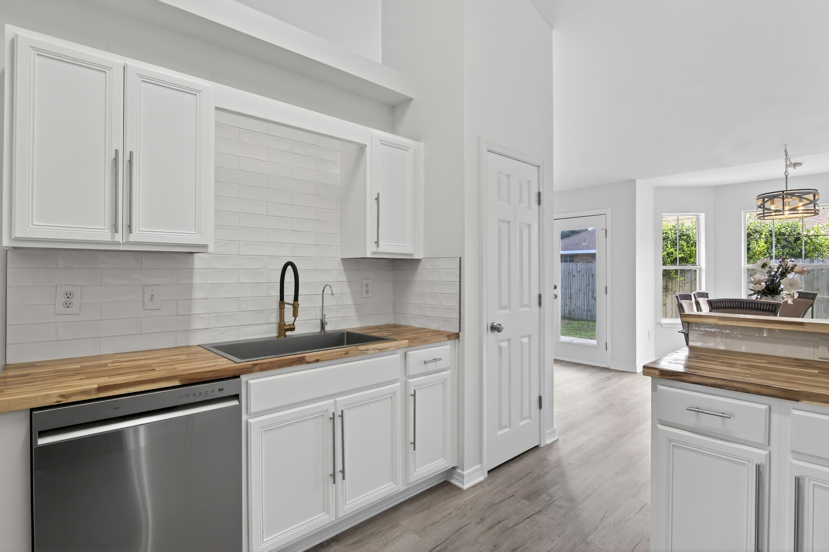 151 Beacon Way Miramar Beach, FL 32550 - Photo 8 of 42 a kitchen with a sink cabinets and wooden floor