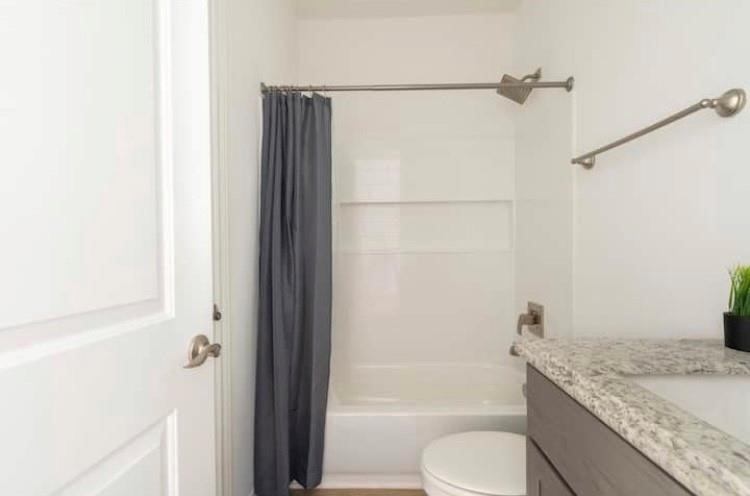 3231 Real Street, Unit B Houston, TX 77087 - Photo 16 of 25 a bathroom with a granite countertop bathtub shower sink vanity and toilet