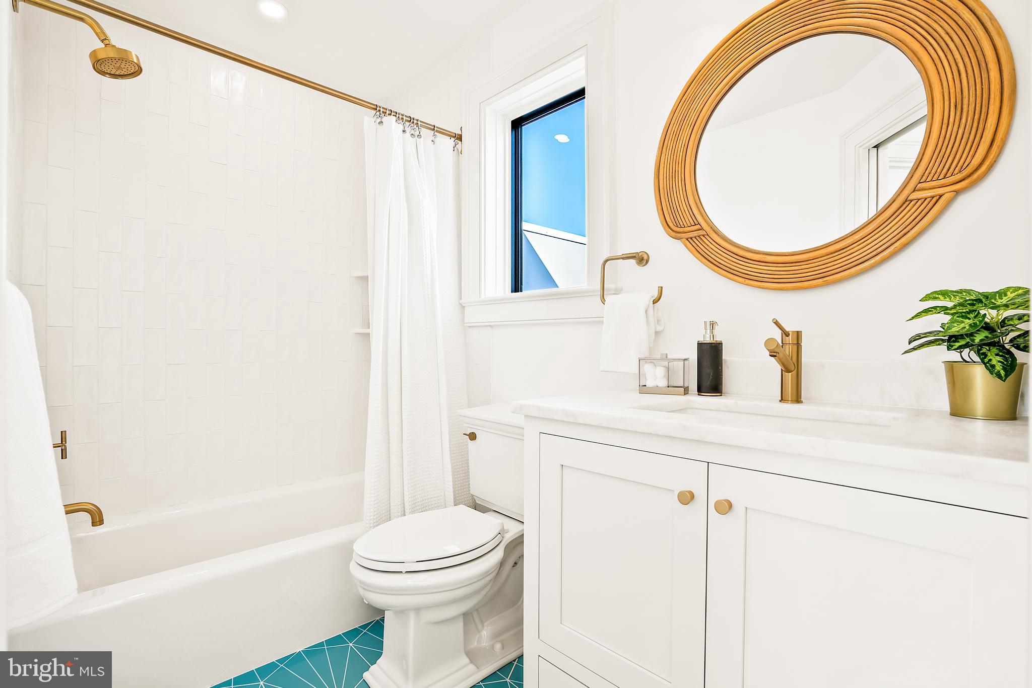 240 11th Street Northeast Washington, DC 20002 - Photo 20 of 32 a bathroom with a sink a mirror and a bathtub