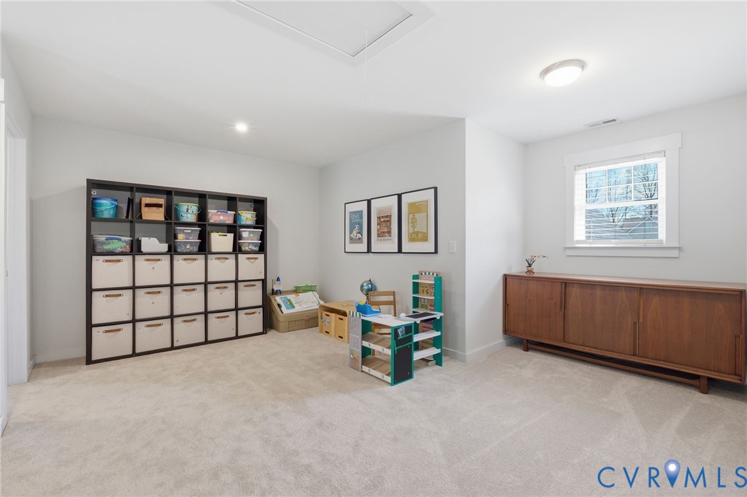 605 Carldan Road Richmond, VA 23227 - Photo 17 of 38 a spacious bedroom with a bed and a window