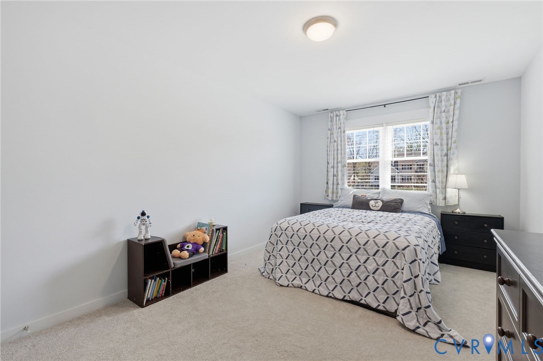 605 Carldan Road Richmond, VA 23227 - Photo 22 of 38 a bedroom with a bed and a window