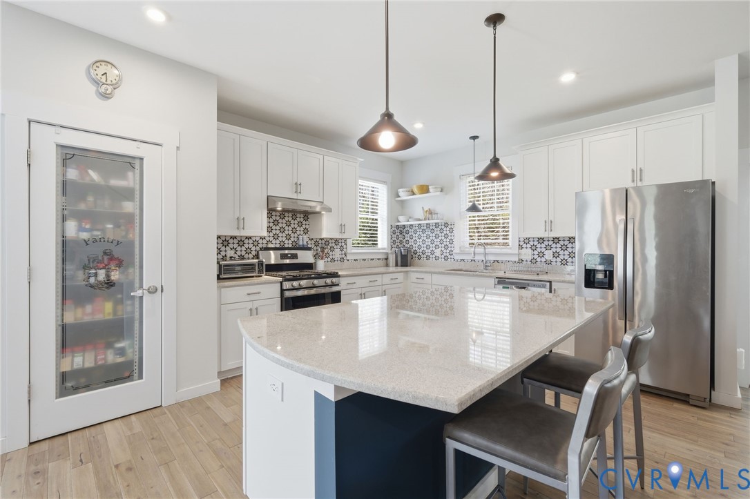605 Carldan Road Richmond, VA 23227 - Photo 6 of 38 a kitchen with stainless steel appliances granite countertop a refrigerator a stove a sink a dining table and chairs