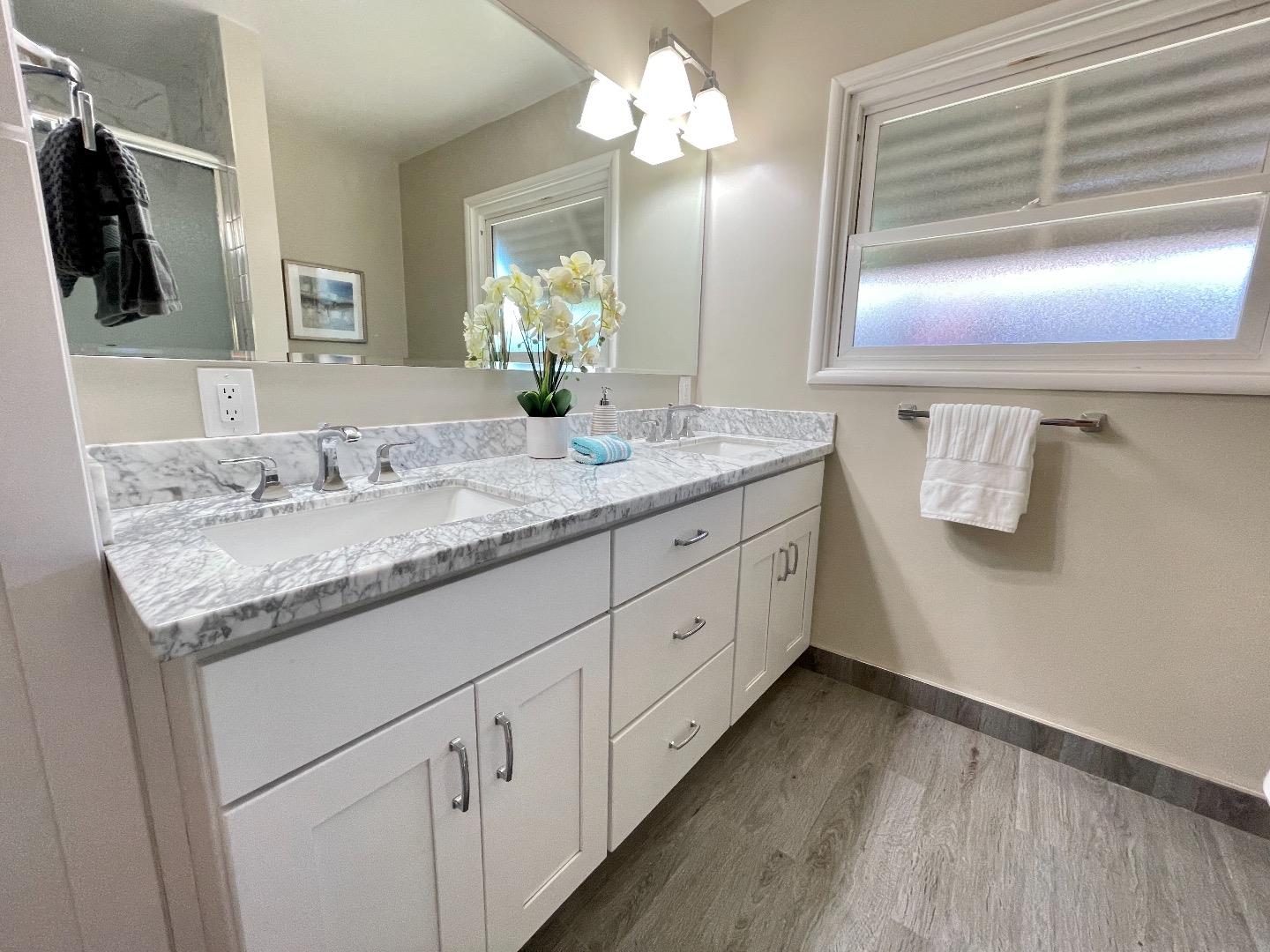 2516 Bailey Avenue San Jose, CA 95128 - Photo 40 of 54 a bathroom with a granite countertop sink a mirror and shower
