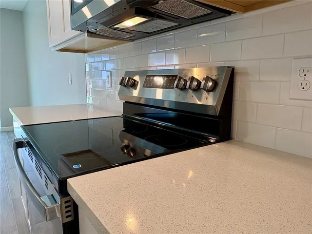 a view of a hallway with wooden floor and entryway
