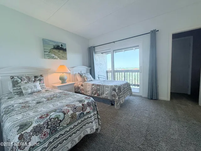 a bedroom with two beds and a window