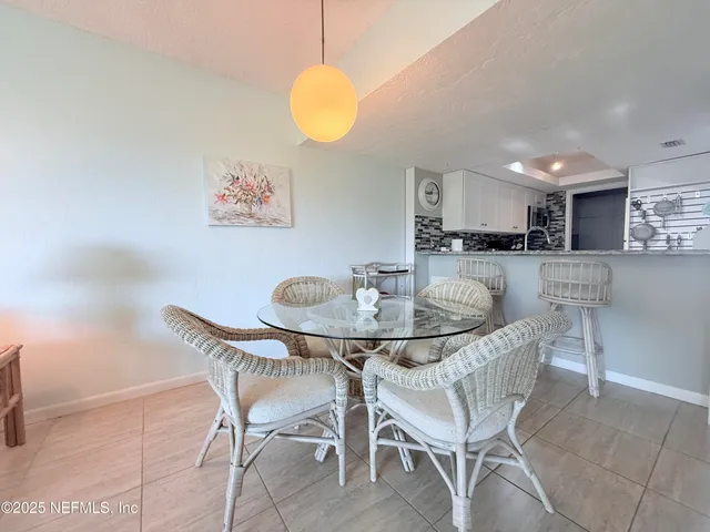 a kitchen with a table and chairs in it
