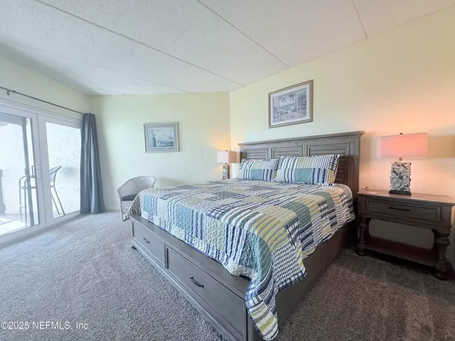 a spacious bedroom with a bed and a large window