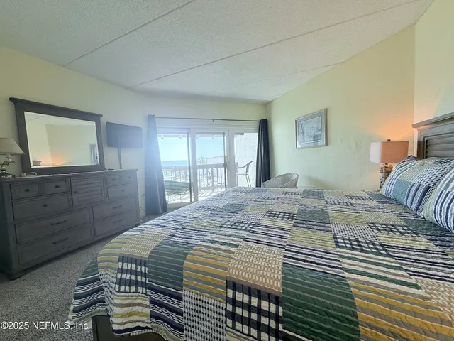 a bedroom with a large bed and a dresser