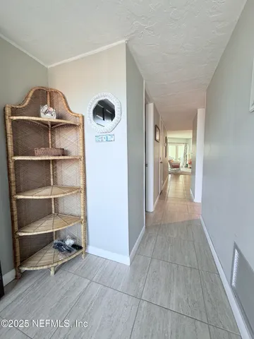 a view of a hallway with wooden shelves