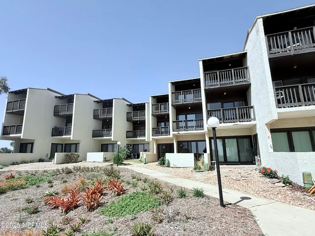 a front view of a building with a yard