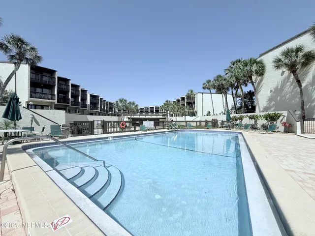 a view of a kitchen with a swimming pool and sitting area