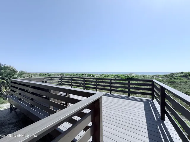 a view of a roof deck with wooden floor and city view