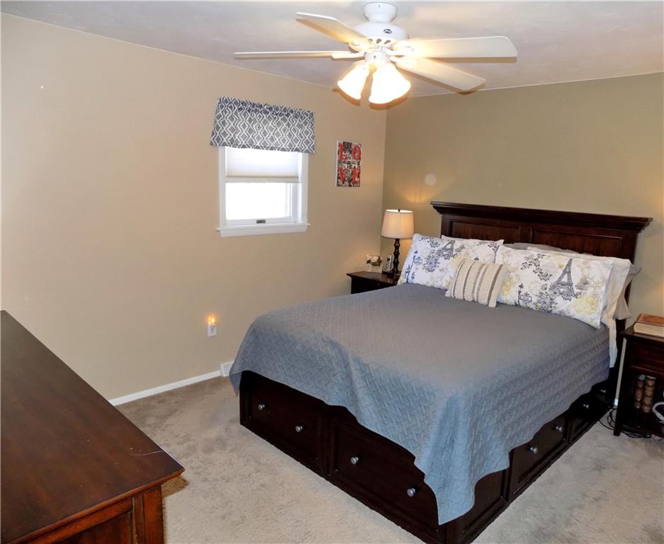 226 Eighty Acres Road Dunbar, PA 15431 - Photo 14 of 26 a bedroom with a bed and a chandelier