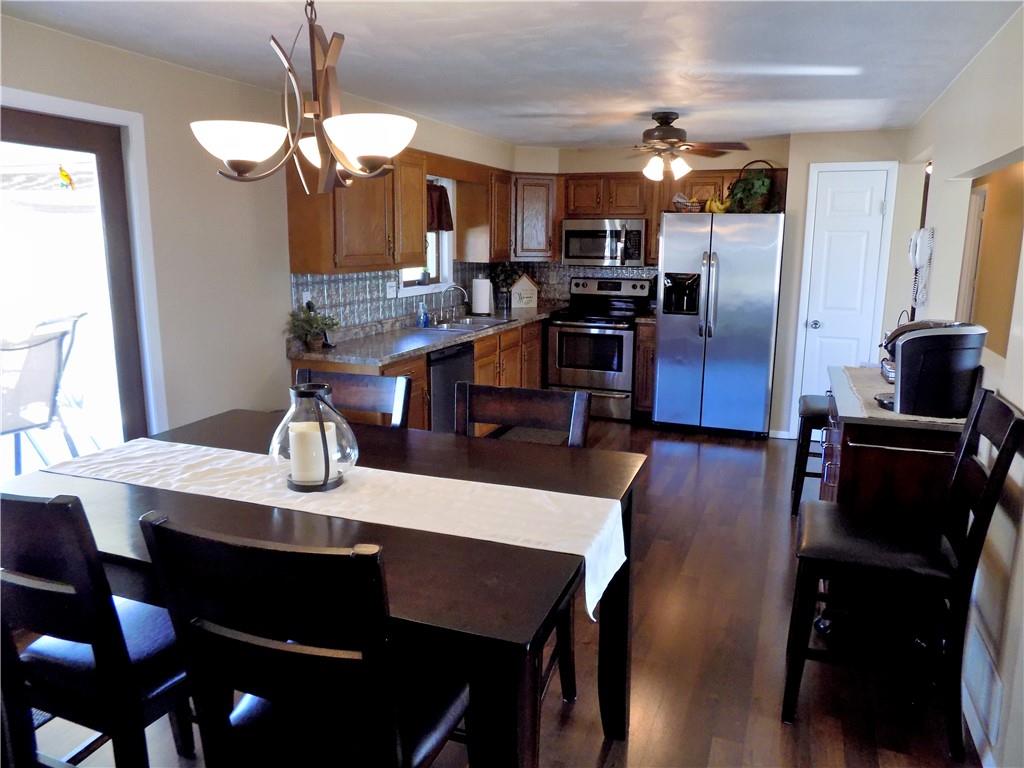 226 Eighty Acres Road Dunbar, PA 15431 - Photo 10 of 26 a kitchen with a dining table chairs and refrigerator