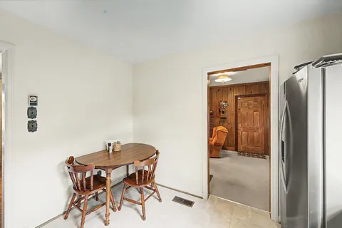 a dining room with a table and chairs