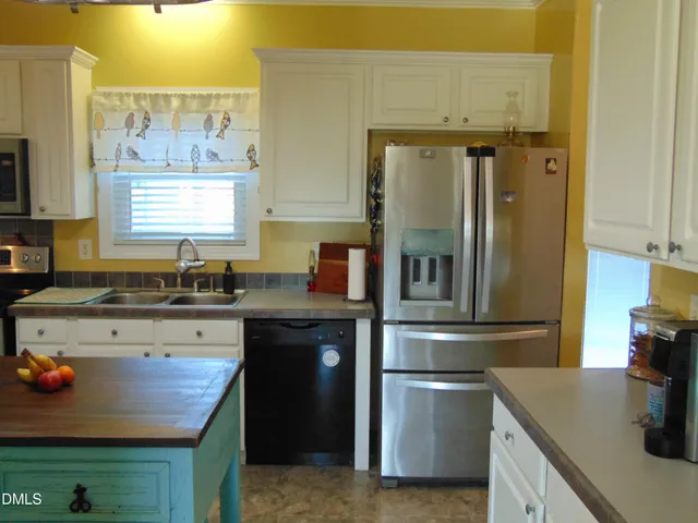 a kitchen with a sink and a washer dryer