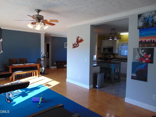 a bed sitting in a bedroom next to a window with dresser