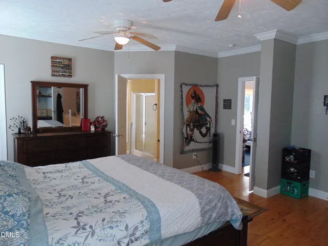 a view of a patio with table and chairs with wooden floor and fence