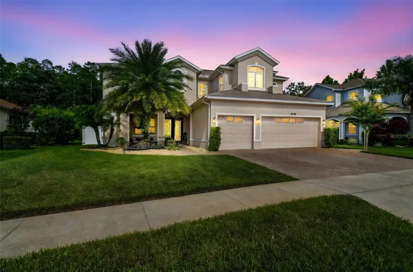 a front view of a house with a garden and yard