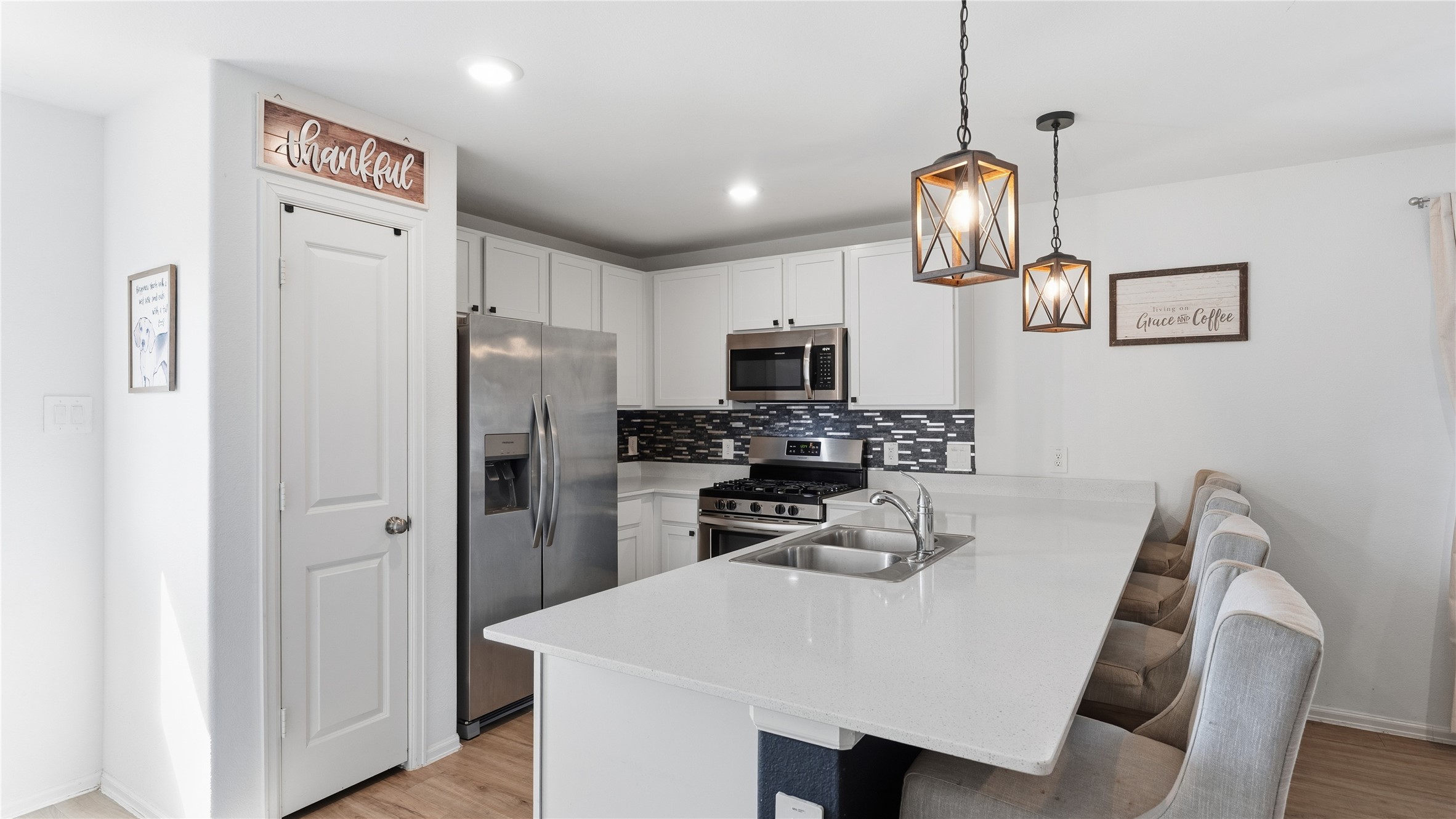 126 Spring Rose Drive Magnolia, TX 77354 - Photo 22 of 48 a kitchen with stainless steel appliances a refrigerator and microwave