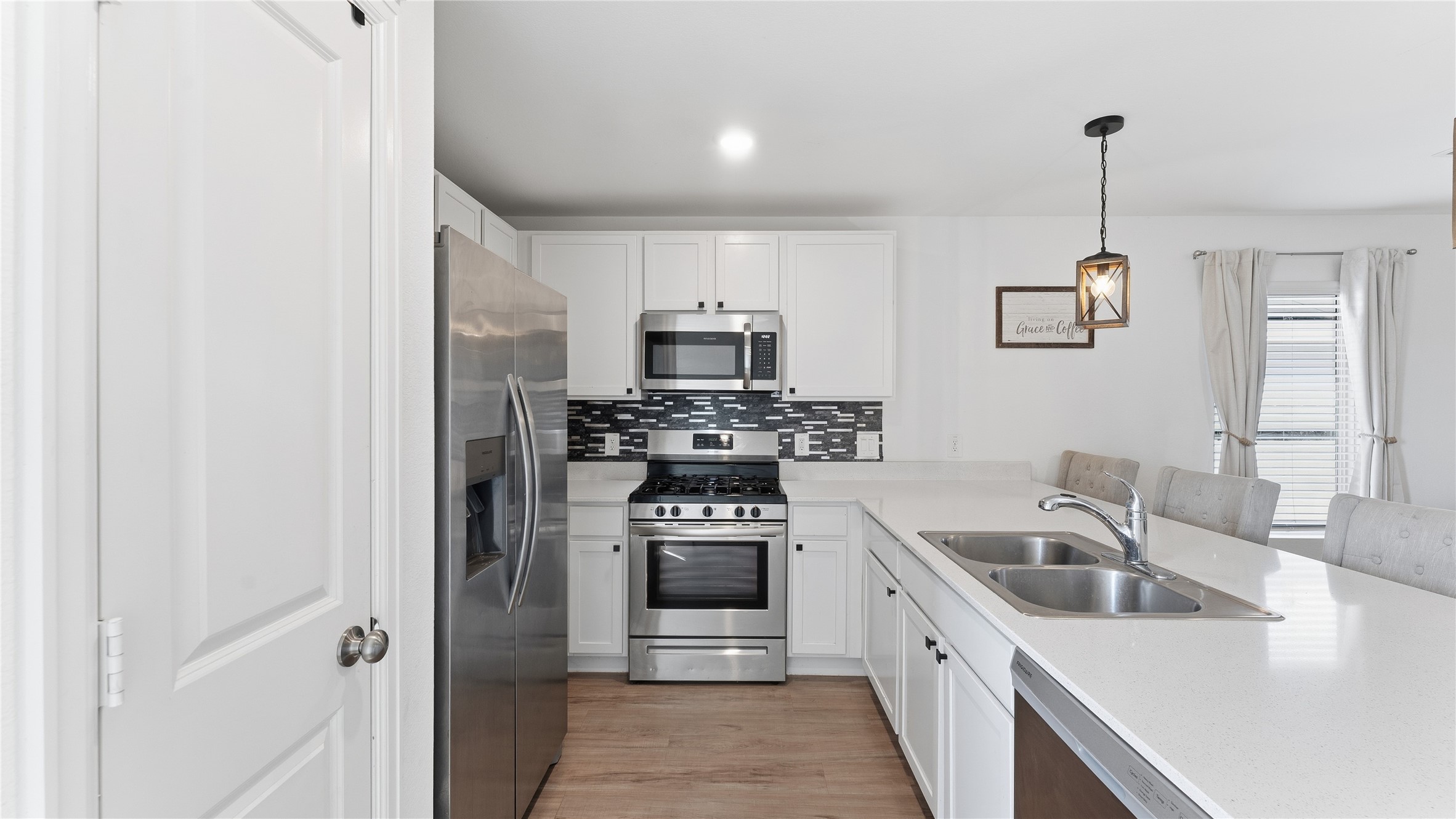 126 Spring Rose Drive Magnolia, TX 77354 - Photo 23 of 48 a kitchen that has a sink cabinets and stainless steel appliances