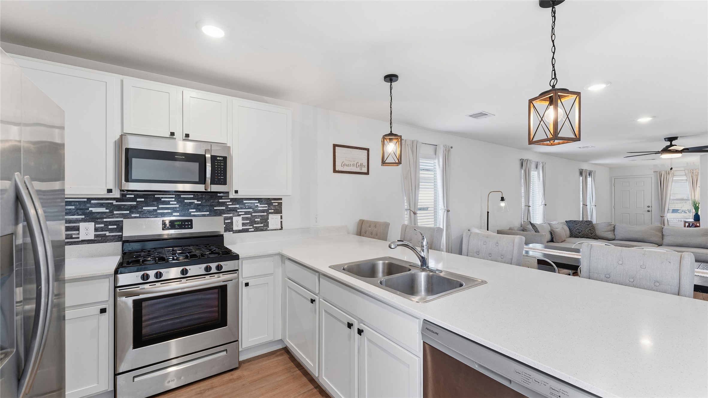 126 Spring Rose Drive Magnolia, TX 77354 - Photo 25 of 48 a kitchen with stainless steel appliances a stove a sink and white cabinets