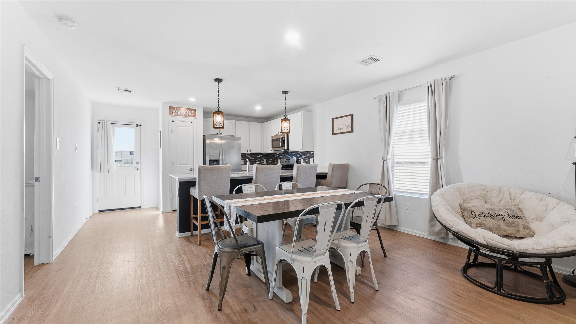 126 Spring Rose Drive Magnolia, TX 77354 - Photo 26 of 48 a view of a dining room with furniture and wooden floor