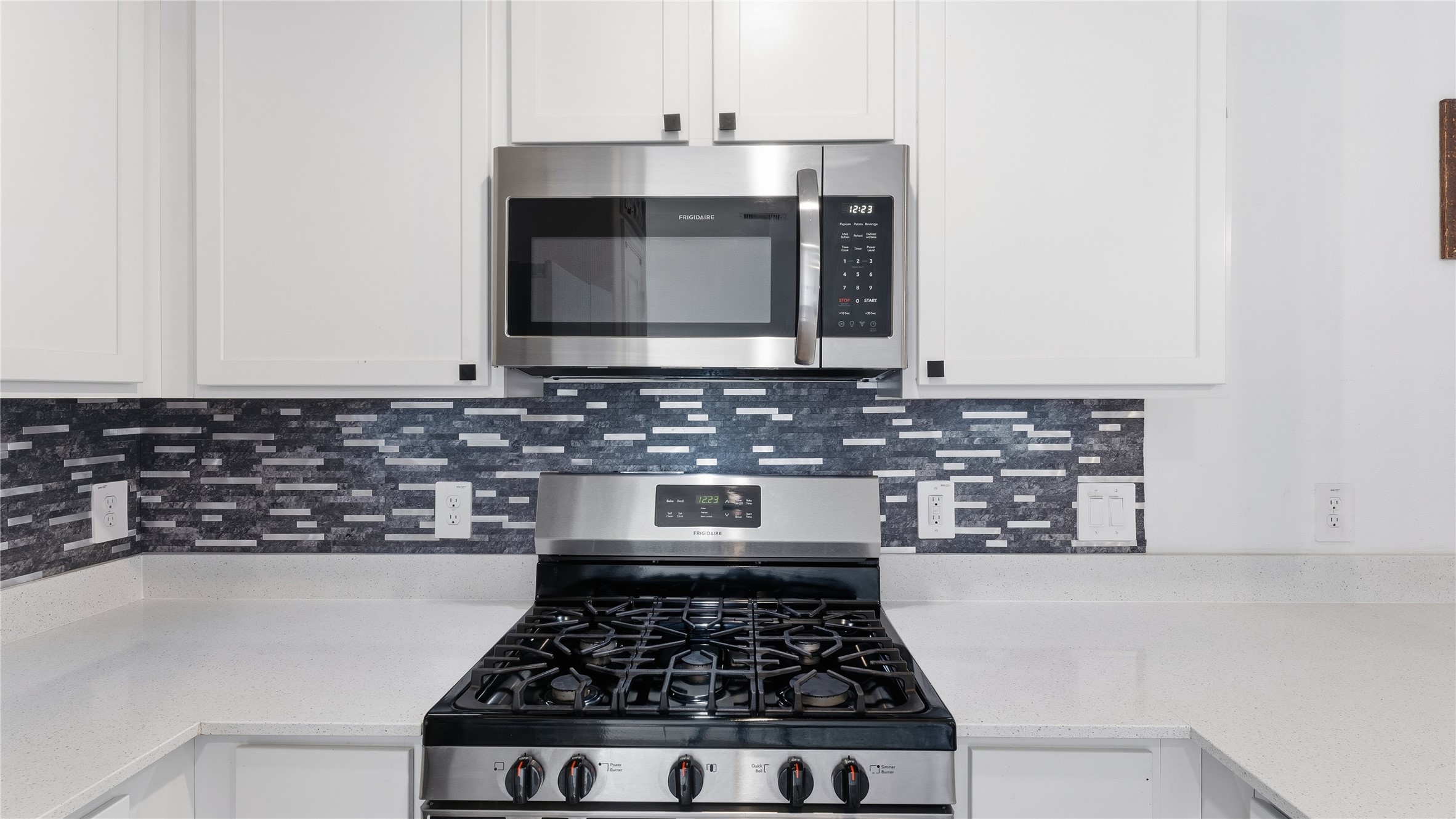 126 Spring Rose Drive Magnolia, TX 77354 - Photo 28 of 48 a kitchen with granite countertop a stove and a microwave