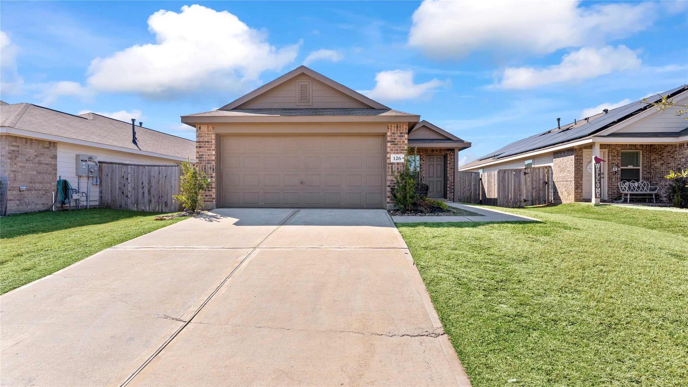 126 Spring Rose Drive Magnolia, TX 77354 - Photo 3 of 48 a front view of a house with a yard and garage