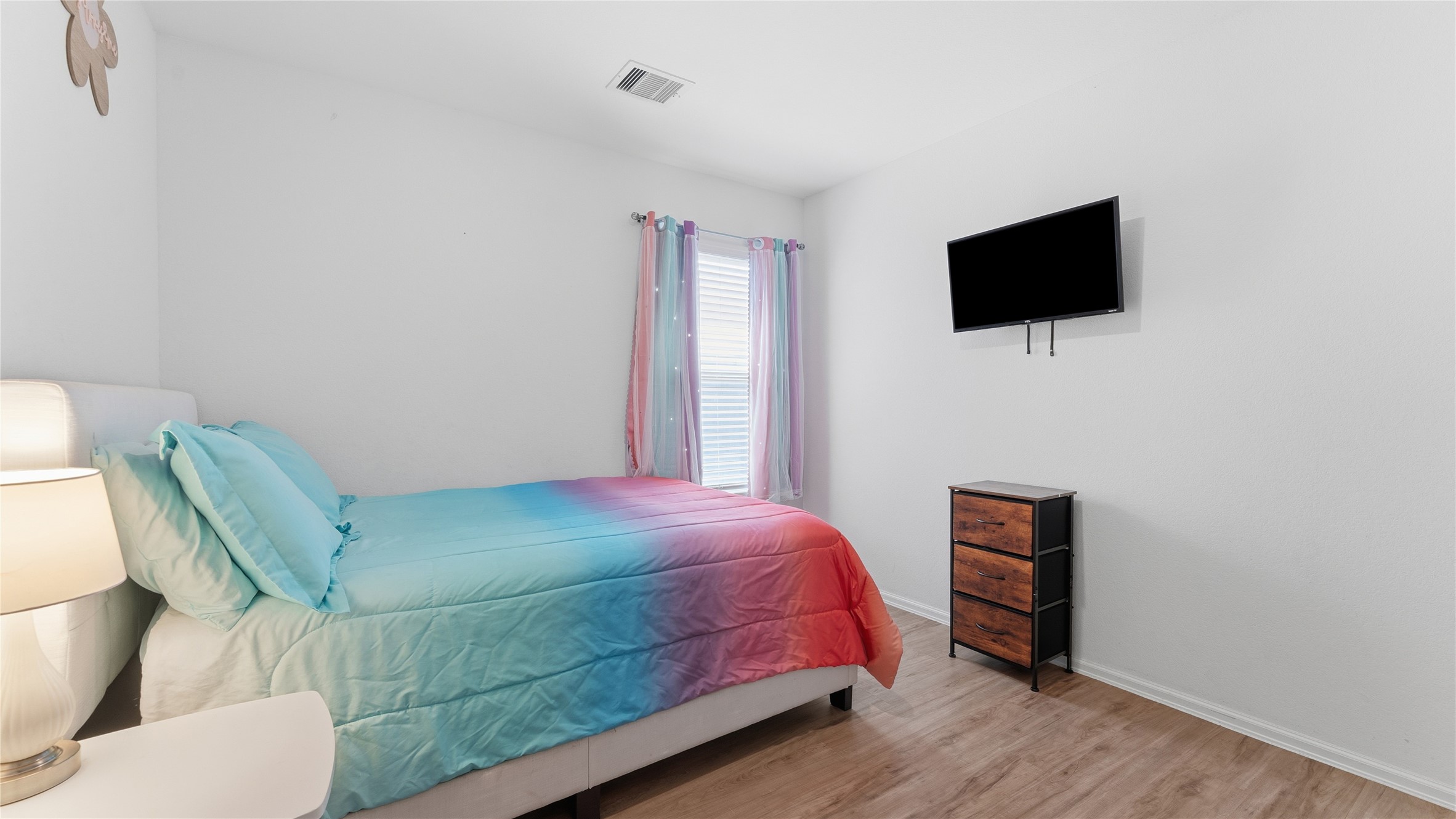 126 Spring Rose Drive Magnolia, TX 77354 - Photo 32 of 48 a bedroom with a bed and a television