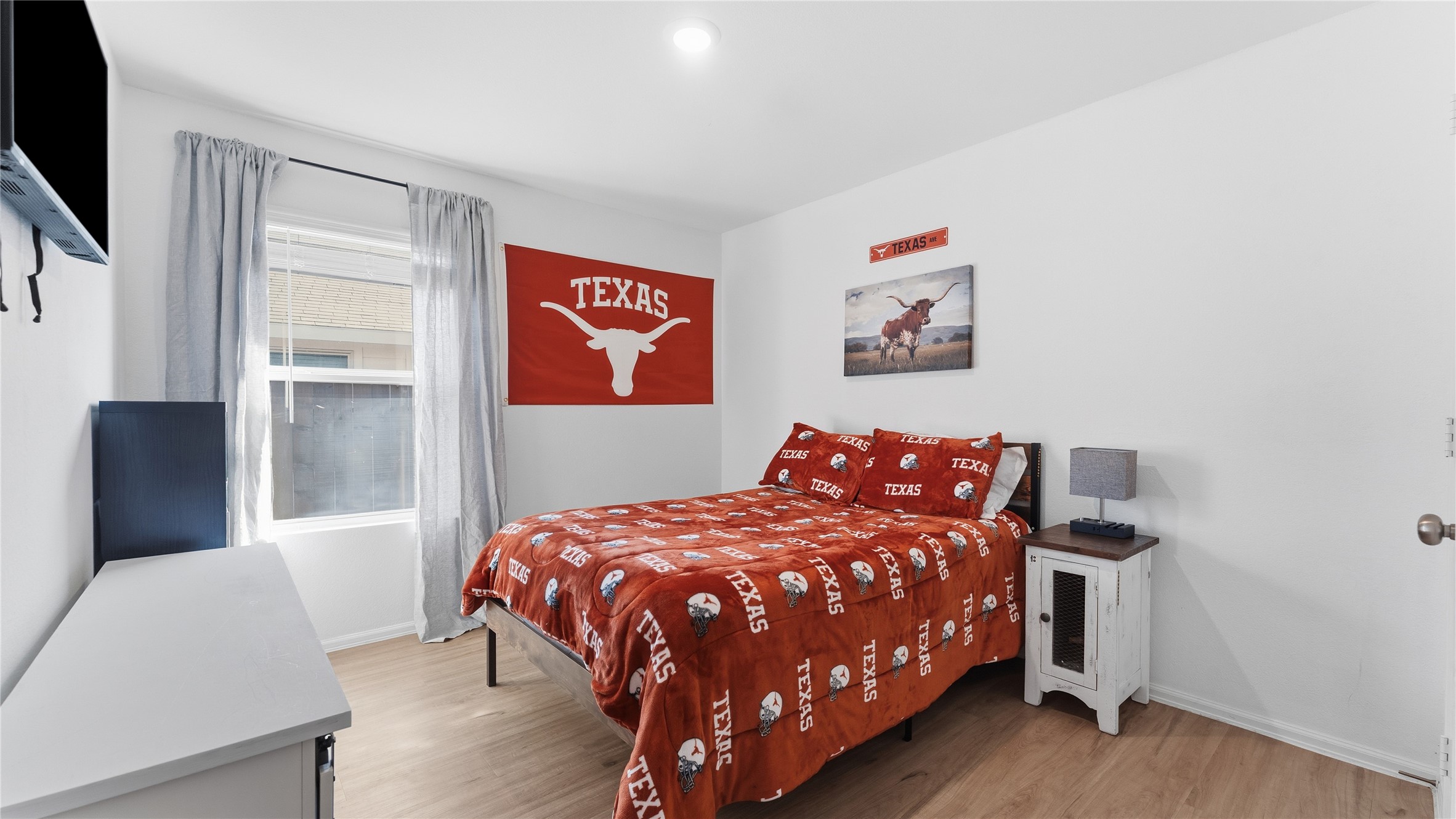 126 Spring Rose Drive Magnolia, TX 77354 - Photo 34 of 48 a bedroom with a bed and wooden floor